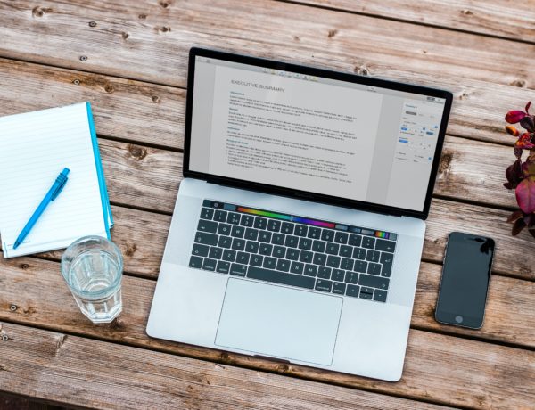 Writing a CV Mac laptop on a table