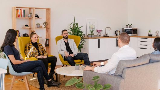 company-team-meeting-work four people work team meeting