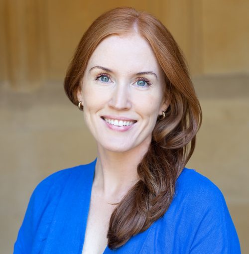 red haired lady business owner wearing royal blue smiling at the camera red haired lady business owner wearing royal blue smiling at the camera