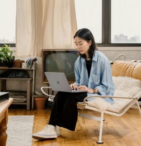 woman-sitting-laptop-working woman sitting in a chair working at a laptop