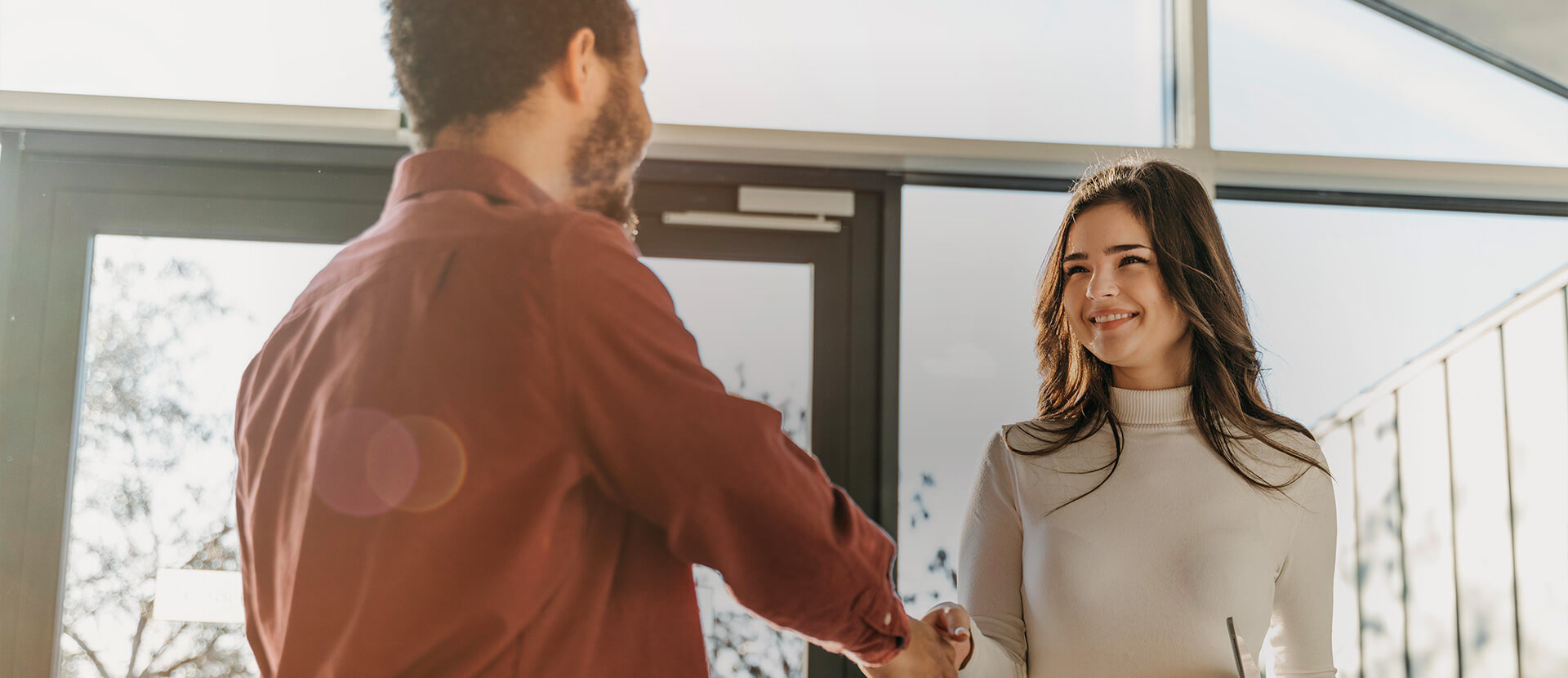 woman and man shaking hands office